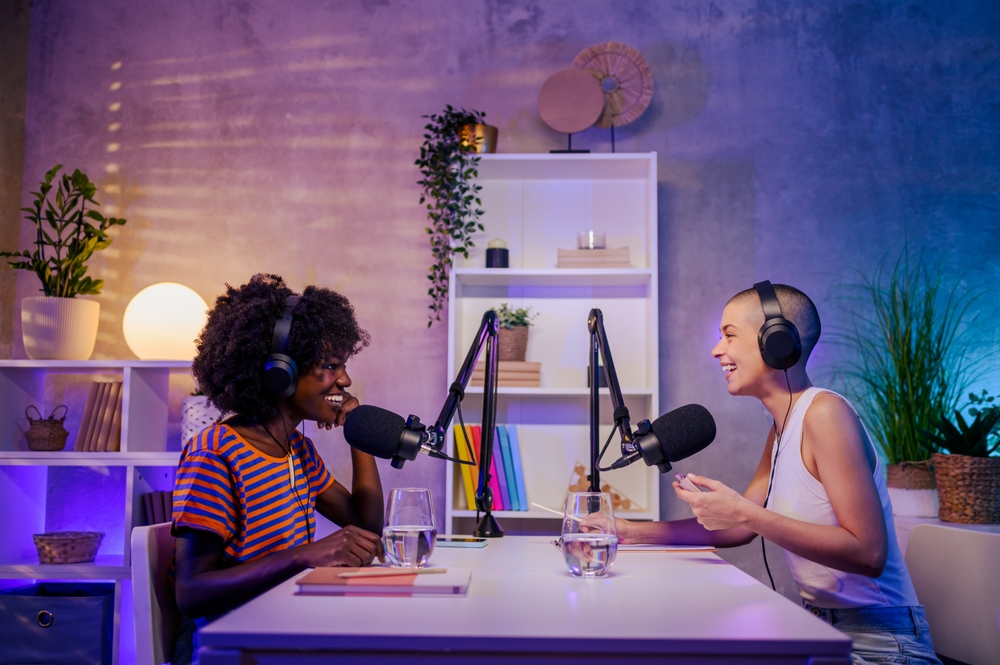 Two female multiracial podcasters